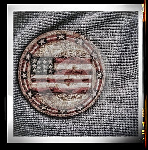 The American flagÃ¢âÂª on a gray background a round patch seen into gray. photo
